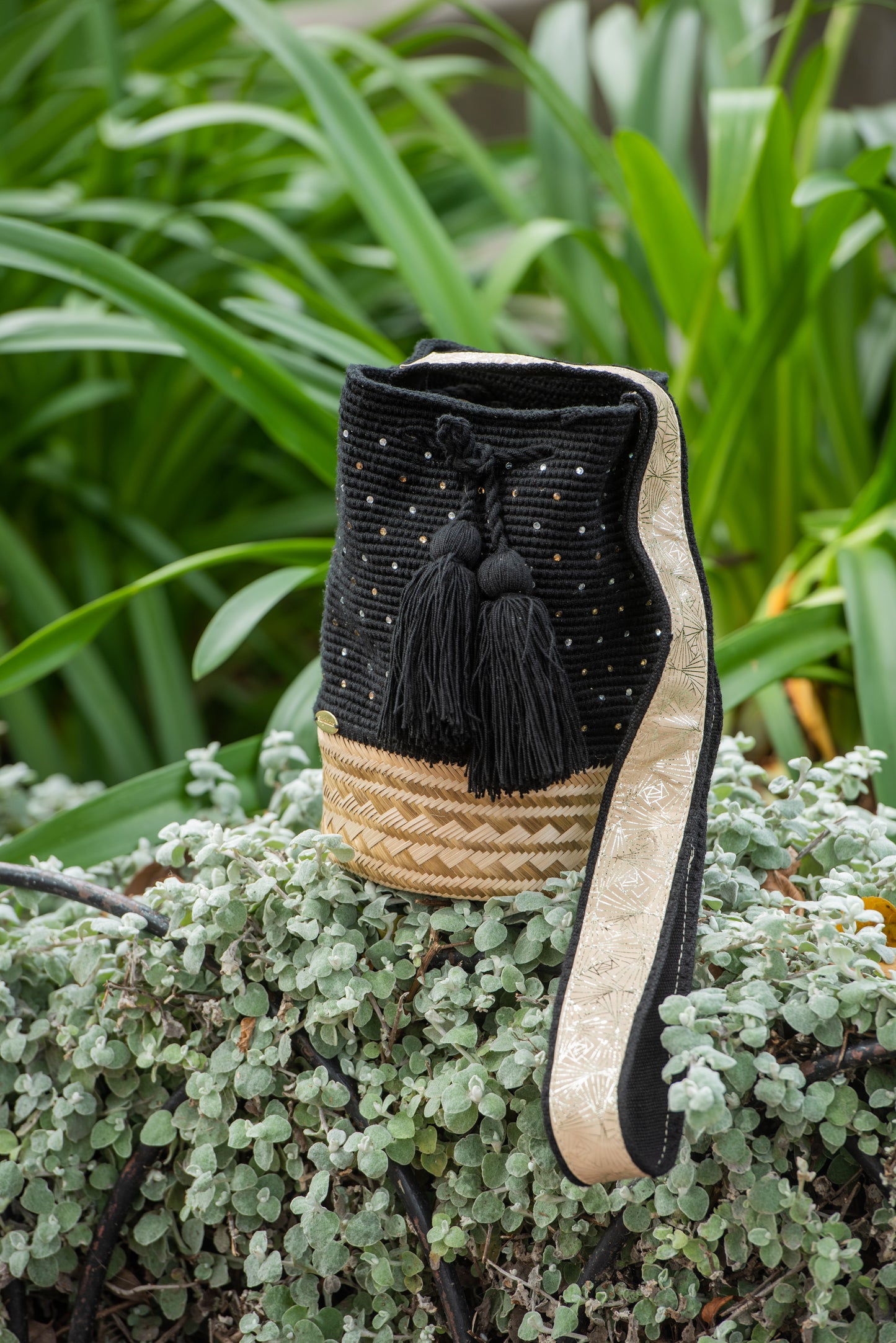 Black Wayuu mochila bag with wicker basket.
