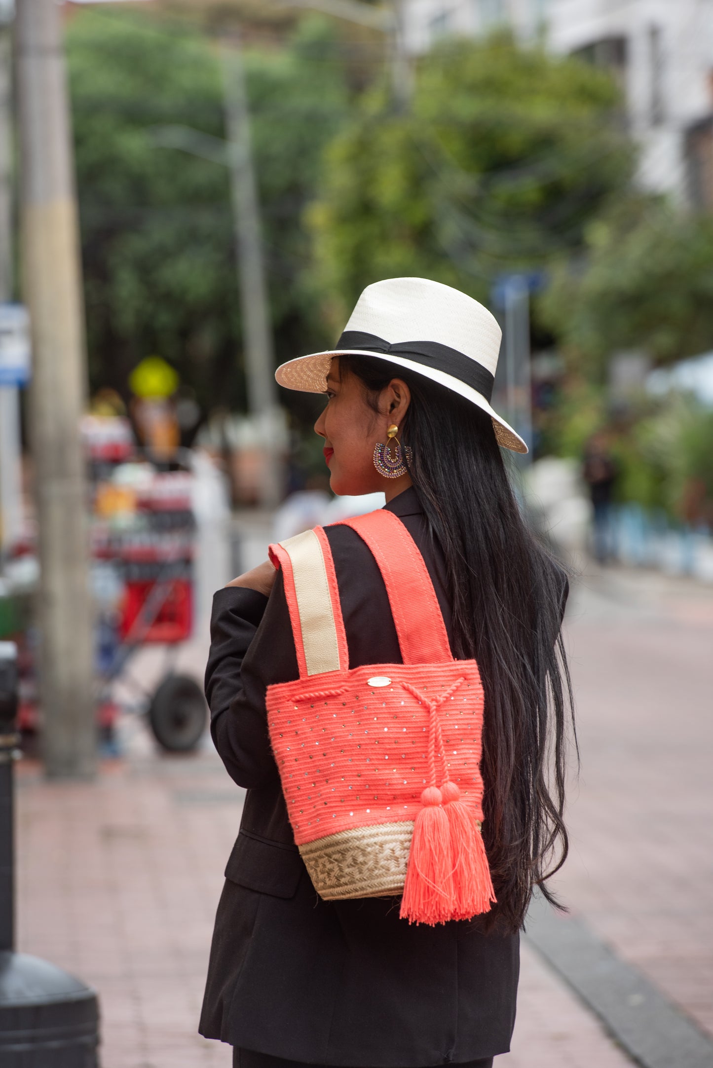 Peach Wayuu mochila bag with wicker basket.